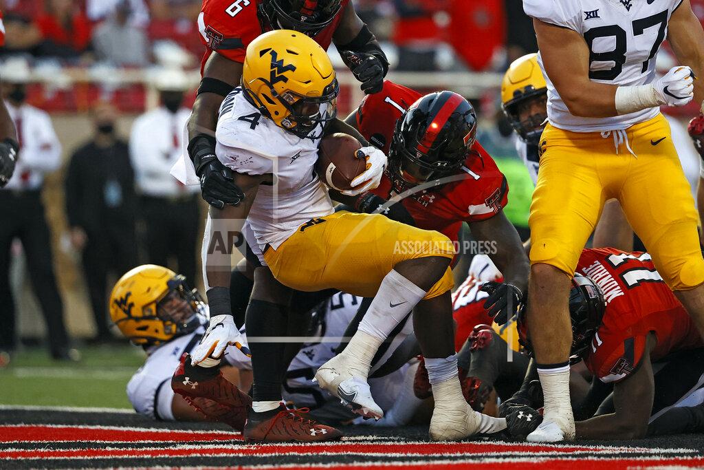 Brad Tollefson West Virginia's Leddie Brown (4) scores a touchdown during the second half of an NCAA college football game against Texas Tech, Saturday, Oct. 24, 2020, in Lubbock, Texas. (AP Photo/Brad Tollefson)