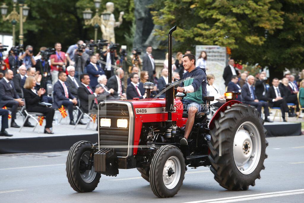 Boris Grdanoski A man on a tractor takes part in a parade to mark the Independence Day in downtown Skopje, North Macedonia, Wednesday, Sept. 8, 2021. North Macedonia is celebrating Wednesday the 30th anniversary since its independence from former Yugoslavia. (AP Photo/Boris Grdanoski)