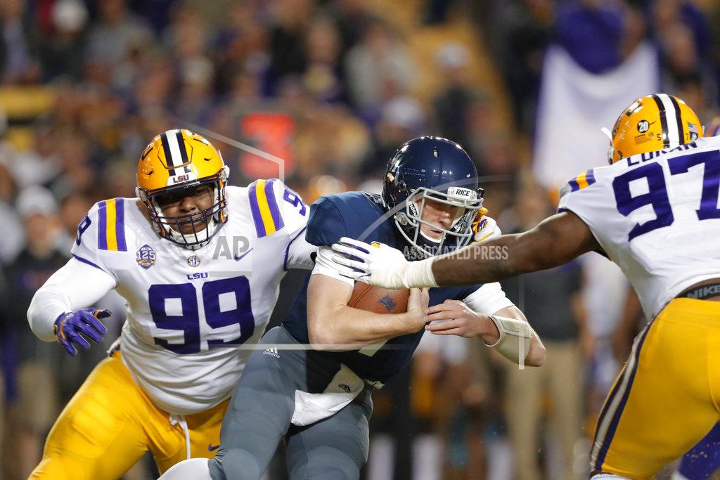 Gerald Herbert Rice quarterback Shawn Stankavage (3) is sacked by LSU nose tackle Ed Alexander (99) and defensive end Glen Logan (97) in the first half of an NCAA college football game in Baton Rouge, La., Saturday, Nov. 17, 2018. (AP Photo/Gerald Herbert)