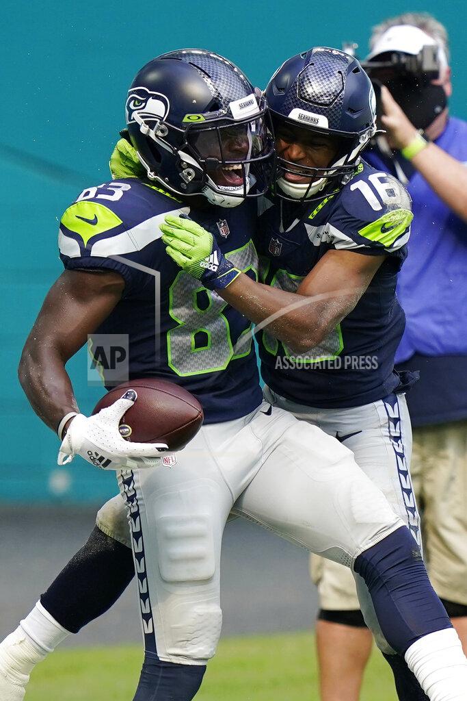 Lynne Sladky Seattle Seahawks wide receiver Tyler Lockett (16) wide receiver David Moore (83) after Moore scored a touchdown, during the second half of an NFL football game against the Miami Dolphins, Sunday, Oct. 4, 2020, in Miami Gardens, Fla. (AP Photo/Lynne Sladky)