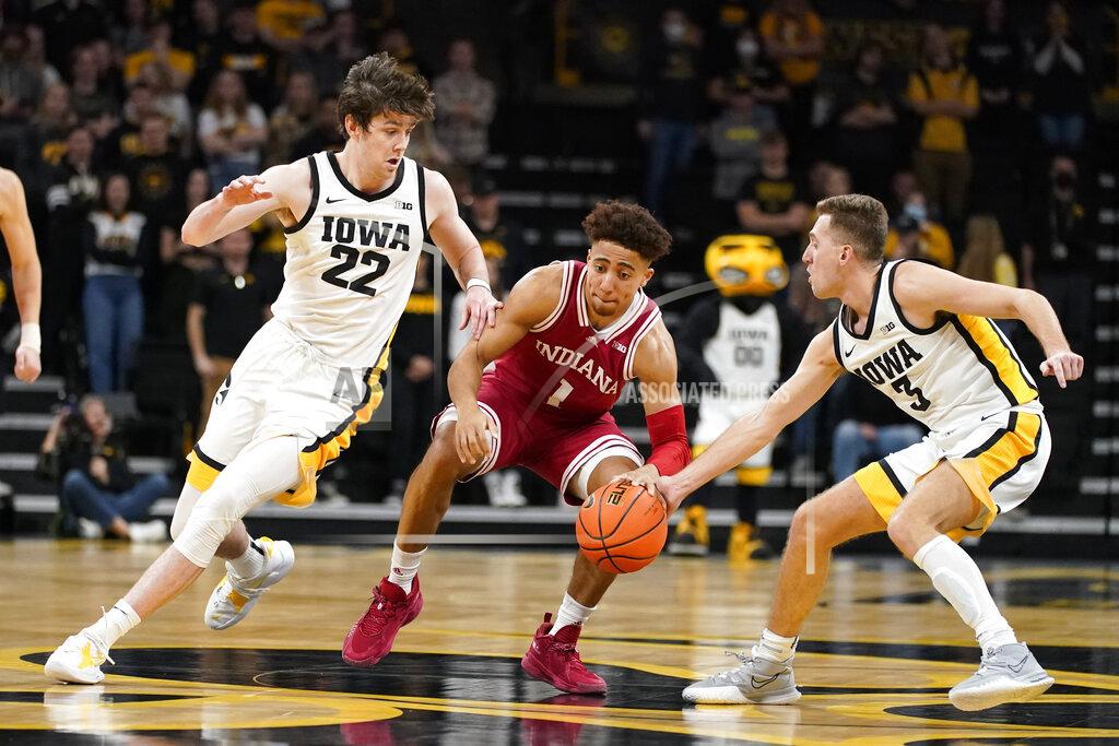 Charlie Neibergall Indiana guard Rob Phinisee (1) drives up court between Iowa forward Patrick McCaffery (22) and guard Jordan Bohannon (3) during the first half of an NCAA college basketball game, Thursday, Jan. 13, 2022, in Iowa City, Iowa. (AP Photo/Charlie Neibergall)