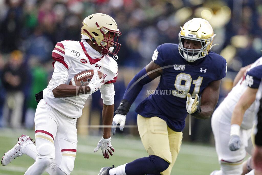 Michael Conroy Boston College wide receiver Zay Flowers (4) cuts around Notre Dame defensive lineman Adetokunbo Ogundeji (91) during the first half of an NCAA college football game in South Bend, Ind., Saturday, Nov. 23, 2019. (AP Photo/Michael Conroy)