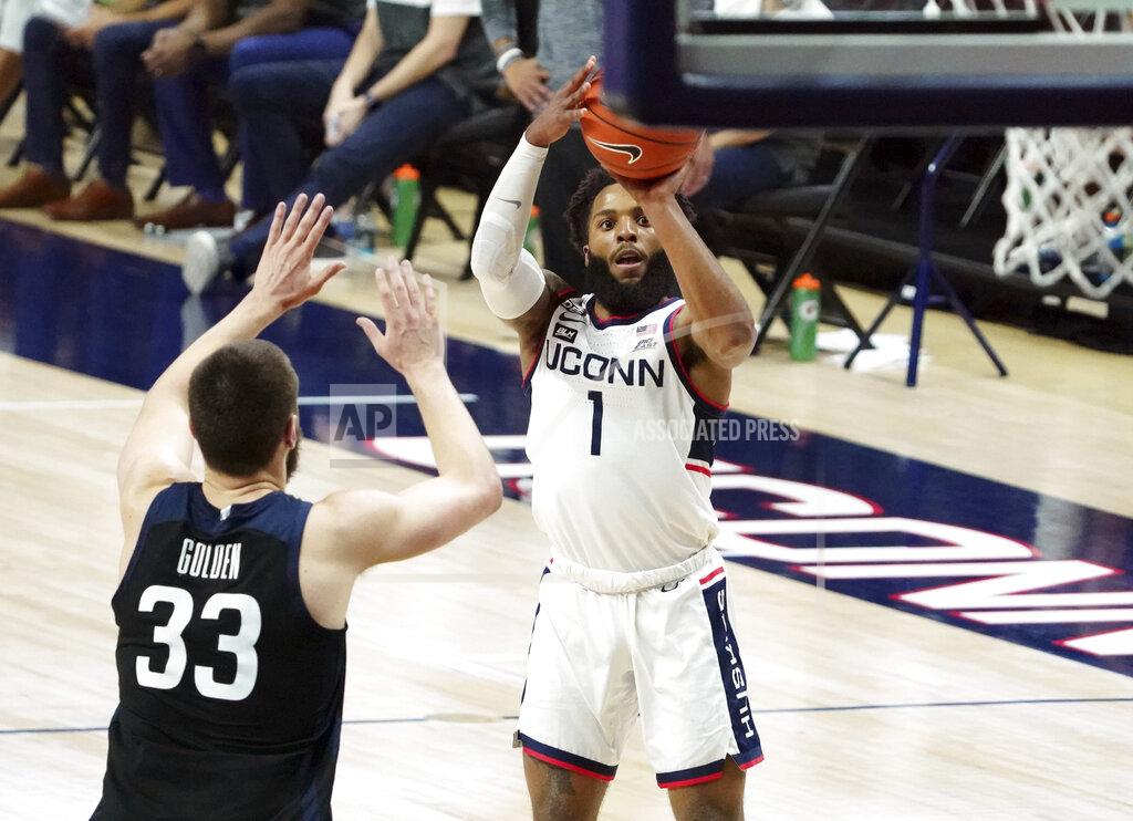 David Butler Ii Connecticut guard R.J. Cole (1) shoots against Butler forward Bryce Golden (33) during the second half of an NCAA college basketball game Tuesday, Jan. 26, 2021, in Storrs, Conn. (David Butler II/Pool Photo via AP)