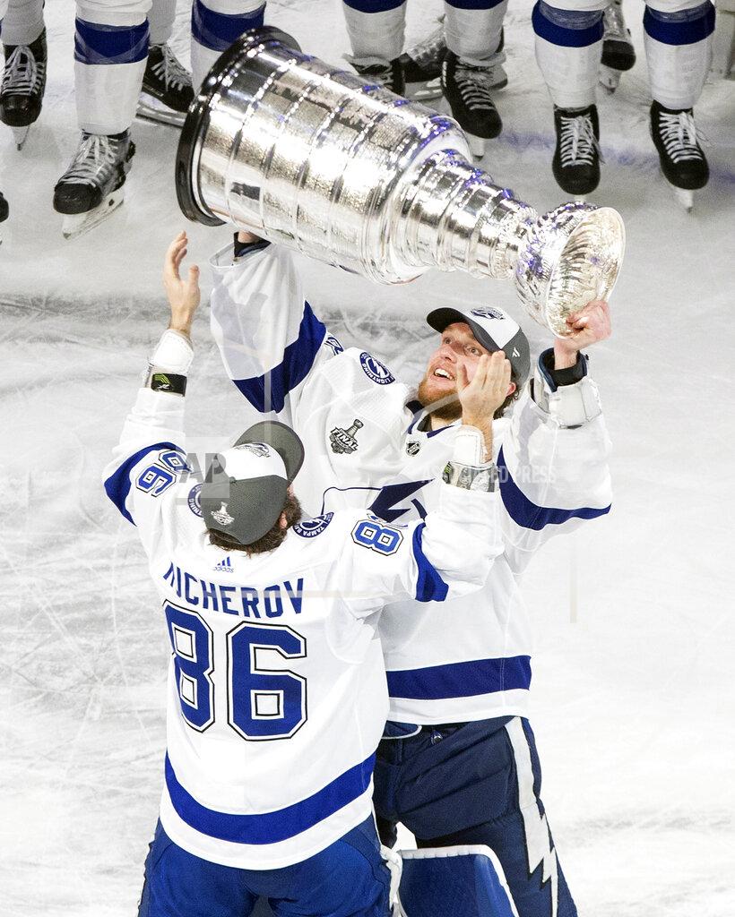 Jason Franson FILE- In this Sept. 28, 2020, file photo, Tampa Bay Lightning's Nikita Kucherov (86) and goalie Andrei Vasilevskiy (88) hoist the Stanley Cup after defeating the Dallas Stars in the NHL Stanley Cup hockey finals, in Edmonton, Alberta. (Jason Franson/The Canadian Press via AP, File)