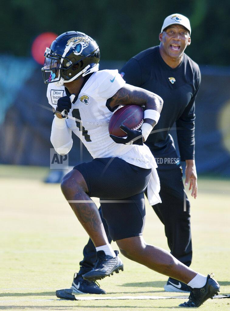 Bob Self Jacksonville Jaguars running back Travis Etienne Jr. (1) sprints with the ball during drills at the NFL football team's training camp, Monday, Aug. 1, 2022, in Jacksonville, Fla. (Bob Self/The Florida Times-Union via AP)