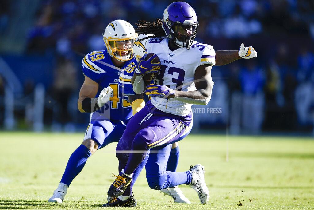 Kelvin Kuo FILE - In this Sunday, Dec. 15, 2019, file photo, Minnesota Vikings running back Dalvin Cook runs with the ball during the first half of an NFL football game against the Los Angeles Chargers in Carson, Calif. The Vikings are expecting Cook to report on time for training camp, coach Mike Zimmer said Saturday, July 25, 2020. Cook has begun the final year of his rookie contract and took a break from the virtual offseason program in June, seeking a new deal. (AP Photo/Kelvin Kuo, File)