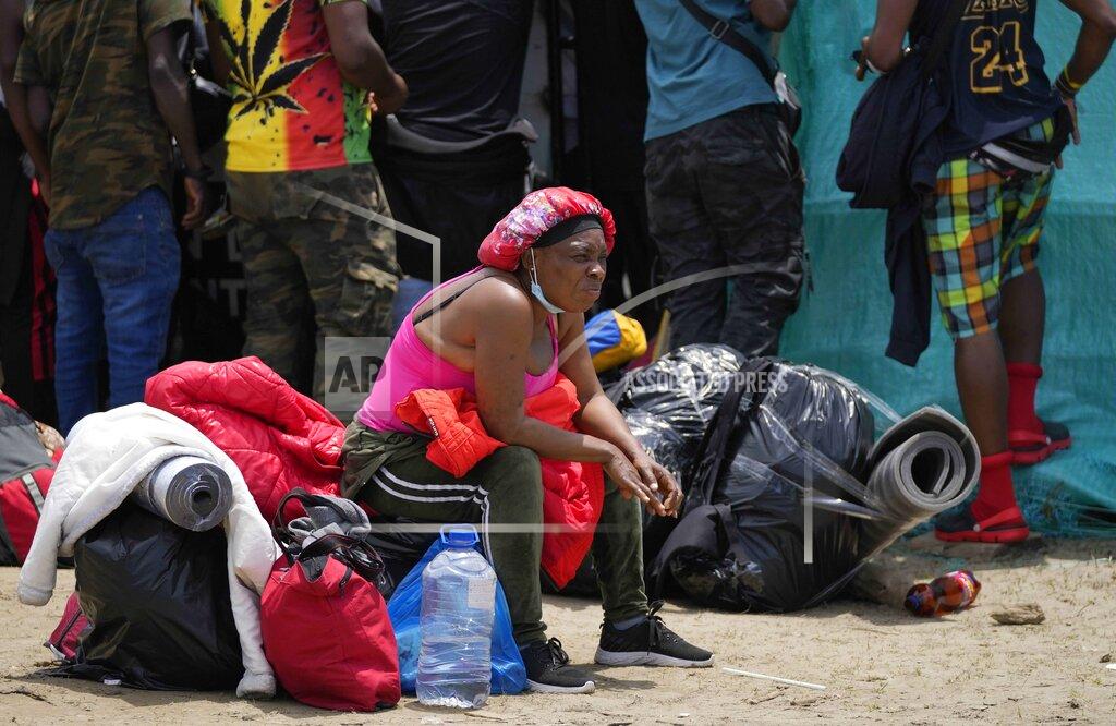 Fernando Vergara Haitian migrants wait to board boats that will take them from Necocli to Acandi, Colombia, near the border with Panama, Monday, Sept. 13, 2021. Migrants have been gathering in Necocli as they move north on their journey to the U.S. border. (AP Photo/Fernando Vergara)