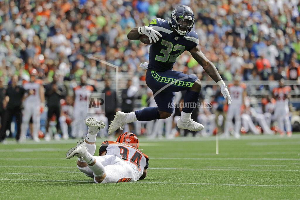 John Froschauer Seattle Seahawks running back Chris Carson leaps over Cincinnati Bengals defensive end Sam Hubbard as he carries the ball during the first half of an NFL football game, Sunday, Sept. 8, 2019, in Seattle. (AP Photo/John Froschauer)