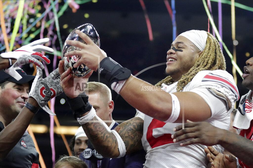 Michael Conroy Ohio State defensive end Chase Young (2) holds the trophy following the team's 34-21 win over Wisconsin in the Big Ten championship NCAA college football game, early Sunday, Dec. 8, 2019, in Indianapolis. (AP Photo/Michael Conroy)