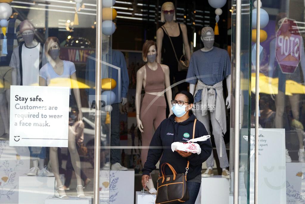Marcio Jose Sanchez Fashions include cloth masks inside a store amid the COVID-19 pandemic Thursday, May 20, 2021, at The Grove in Los Angeles. California regulators will shoot for a mid-June easing of workplace masking and social distancing requirements to conform with a broader state order. They asked to delay a debate Thursday on how quickly they should drop coronavirus safety rules for employees. (AP Photo/Marcio Jose Sanchez)