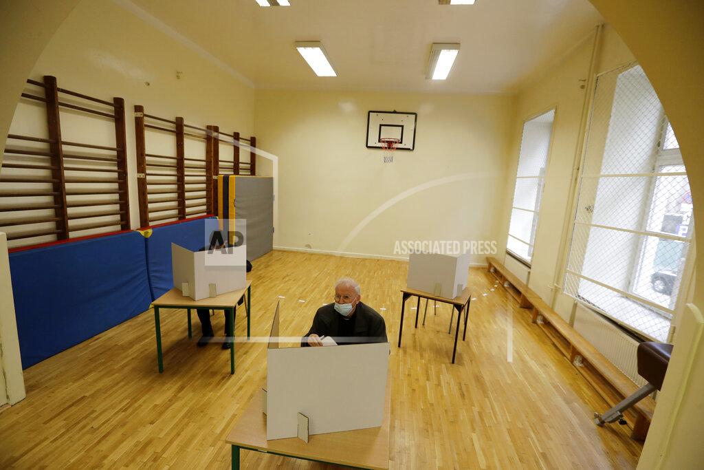 Petr David Josek A man prepares his vote during presidential runoff election in Krakow, Poland, Sunday, July 12, 2020. Voting started Sunday in Poland’s razor-blade-close presidential election runoff between the conservative incumbent Andrzej Duda and liberal, pro-European Union Warsaw Mayor Rafal Trzaskowski. (AP Photo/Petr David Josek)