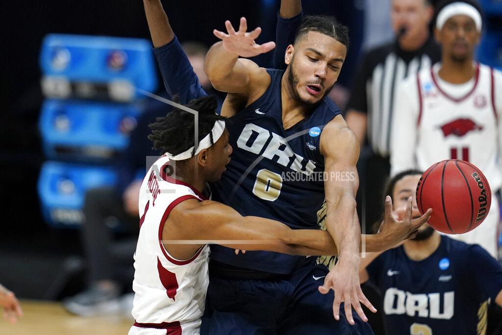 Jeff Roberson Arkansas guard JD Notae, left, passes around Oral Roberts forward Kevin Obanor (0) during the first half of a Sweet 16 game in the NCAA men's college basketball tournament at Bankers Life Fieldhouse, Saturday, March 27, 2021, in Indianapolis. (AP Photo/Jeff Roberson)