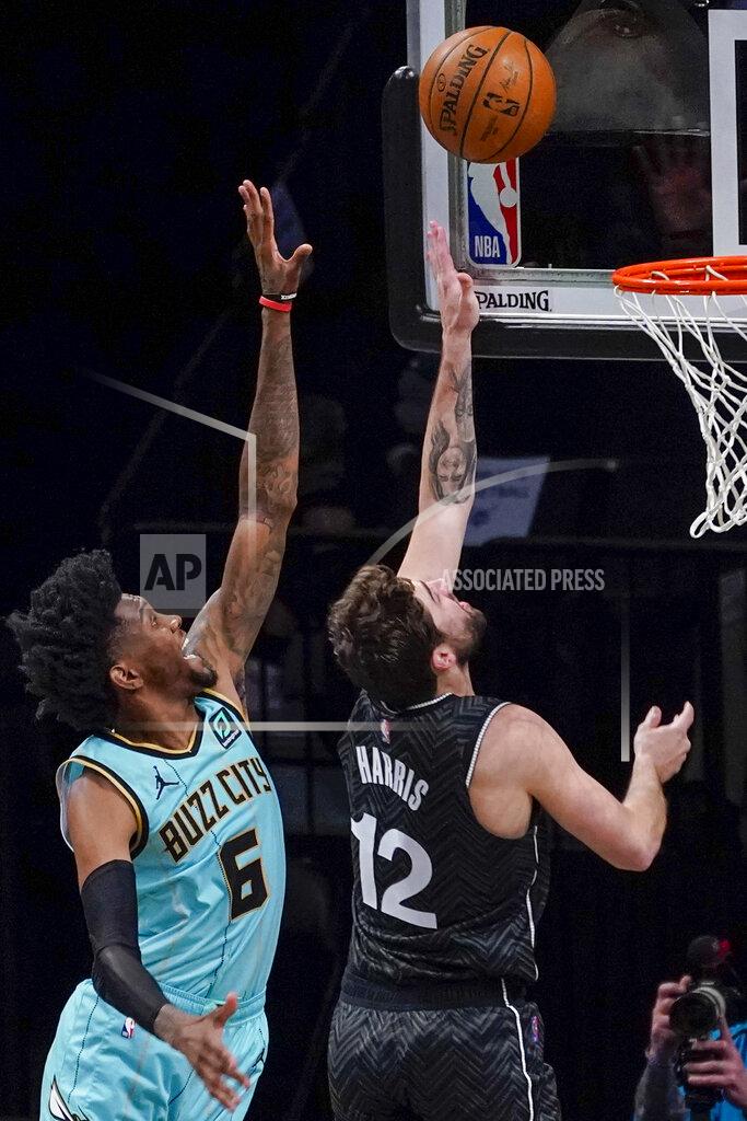 Mary Altaffer Brooklyn Nets forward Joe Harris (12) goes to the basket past Charlotte Hornets forward Jalen McDaniels (6) during the second half of an NBA basketball game Friday, April 16, 2021, in New York. (AP Photo/Mary Altaffer)