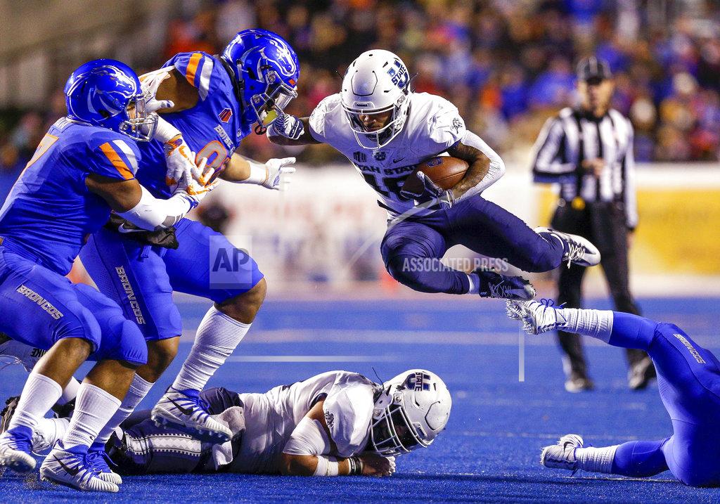 Steve Conner Utah State wide receiver Jordan Nathan (16) leaps over a teammate and a Boise State defender during the first half of an NCAA college football game Saturday, Nov. 24, 2018, in Boise, Idaho. (AP Photo/Steve Conner)