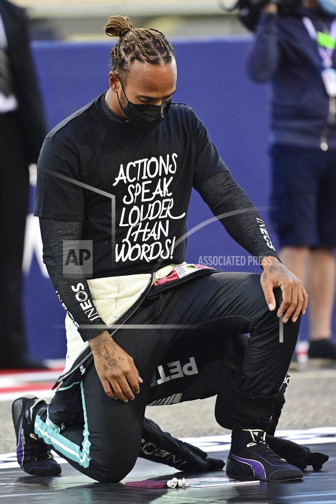 Andrej Isakovic Mercedes driver Lewis Hamilton of Britain takes a knee in support of Black Lives Matter movement at the starting grid prior to the start of the Bahrain Formula One Grand Prix at the Bahrain International Circuit in Sakhir, Bahrain, Sunday, March 28, 2021. (Andrej Isakovic, Pool via AP)
