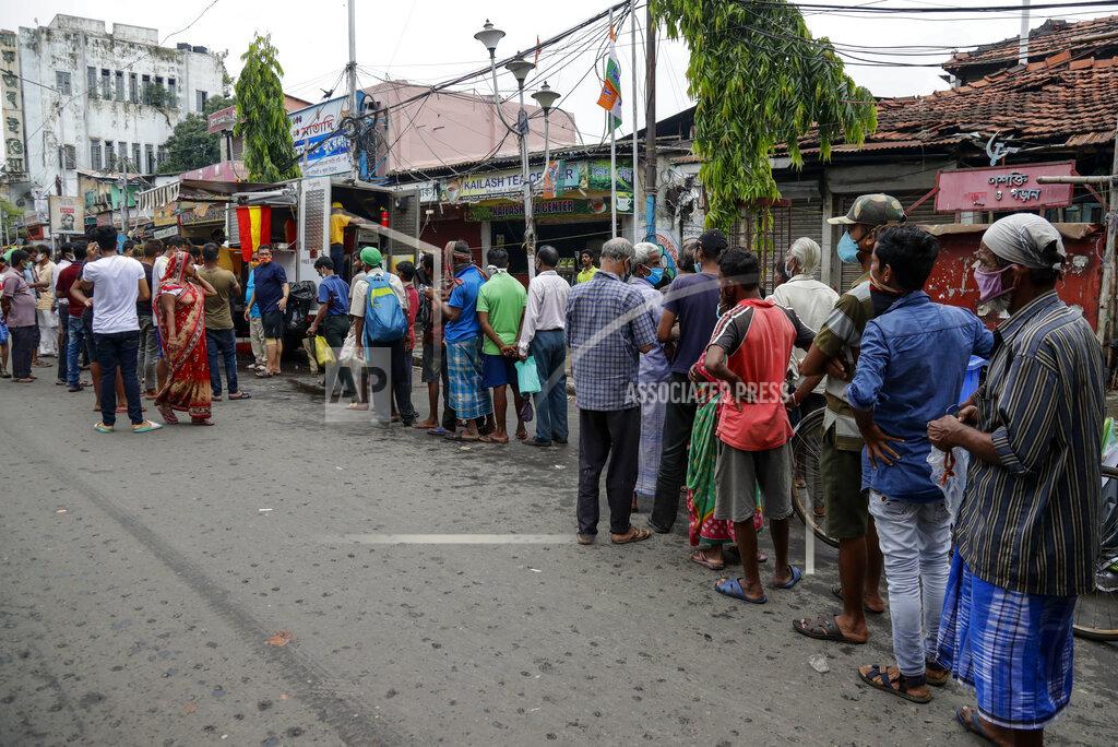 Bikas Das People line up to receive free meal distributed by a voluntary organization during relaxation hours of a lockdown put in place to curb the spread of coronavirus pandemic in Kolkata, India, Wednesday, June 16, 2021. (AP Photo/Bikas Das)