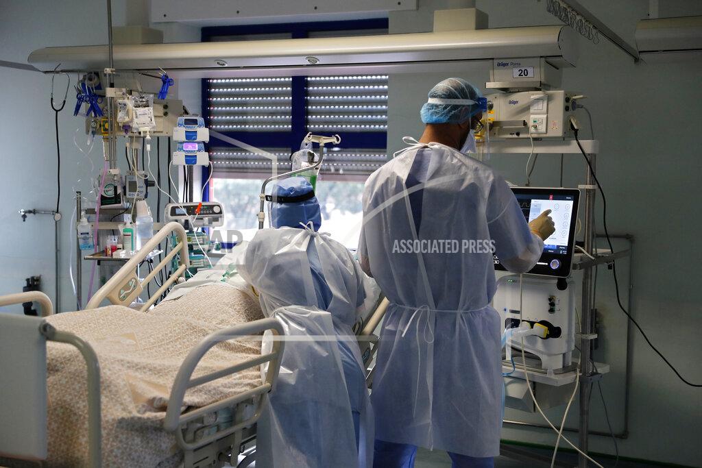 Armando Franca A nurse and a doctor, right, tend to a patient in a COVID-19 Intensive Care Unit at the Curry Cabral hospital in Lisbon, Thursday, Feb. 11, 2021. After Portugal figured for about two weeks last month as the world’s worst-hit country by size of population, anxiety over the recent pandemic peak has eased slightly. The number of COVID-19 patients in hospital and in intensive care fell Thursday for the third straight day. The health ministry reported the fewest hospitalizations since Jan. 20 and the fewest patients in ICUs for almost two weeks. (AP Photo/Armando Franca)