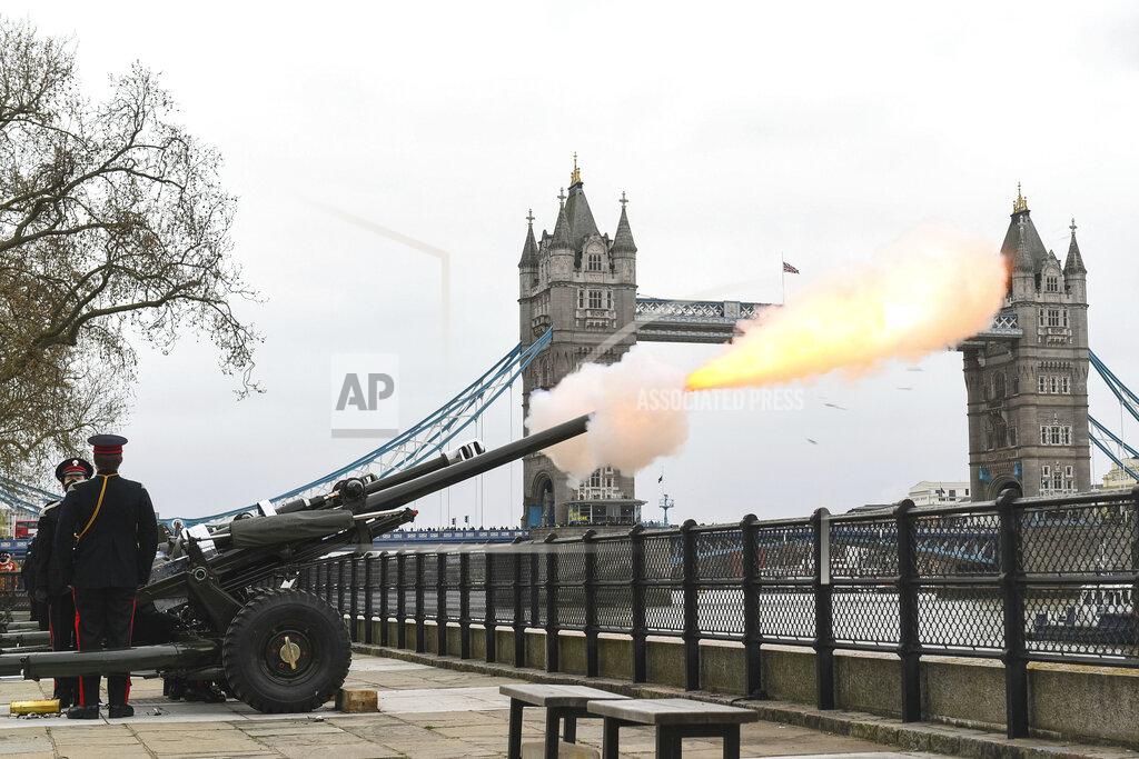 Dominic Lipinski Members of the Honourable Artillery Company fire a 41-round gun salute from the wharf at the Tower of London, to mark the death of Prince Philip, in London, Saturday, April 10, 2021. Britain's Prince Philip, the irascible and tough-minded husband of Queen Elizabeth II who spent more than seven decades supporting his wife in a role that mostly defined his life, died on Friday. (Dominic Lipinski/PA via AP)
