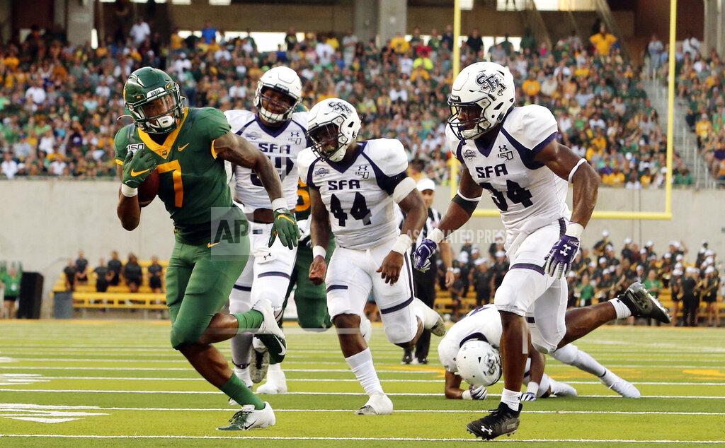 Jose Yau Baylor running back John Lovett (7) scores past Stephen F. Austin linebacker Bert Morris (44) and safety Gavin Roland (34) in the first half of an NCAA college football game, Saturday, Aug. 31, 2019, in Waco, Texas. (Jose Yau/Waco Tribune-Herald via AP)
