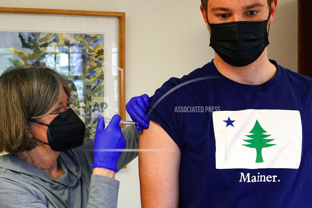 Robert F. Bukaty Nurse Sharon Daley administers a COVID-19 vaccination to Oliver Blank, 18, Friday, March 19, 2021, on the island of Islesford, Maine. An exemption has been made to the vaccination age restrictions to allow younger residents on remote islands to receive their shot. (AP Photo/Robert F. Bukaty)