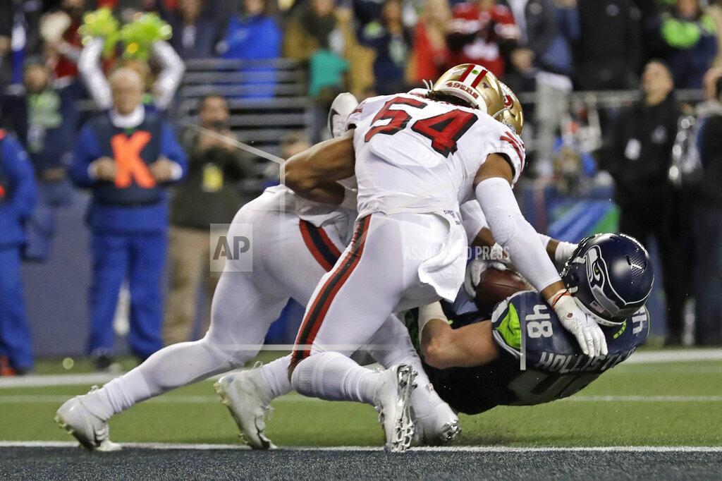 Ted S. Warren Seattle Seahawks tight end Jacob Hollister (48) is stopped just short of the goal line by San Francisco 49ers middle linebacker Fred Warner (54) and linebacker Dre Greenlaw, left, during the second half of an NFL football game, Sunday, Dec. 29, 2019, in Seattle. The 49ers won 26-21. (AP Photo/Ted S. Warren)