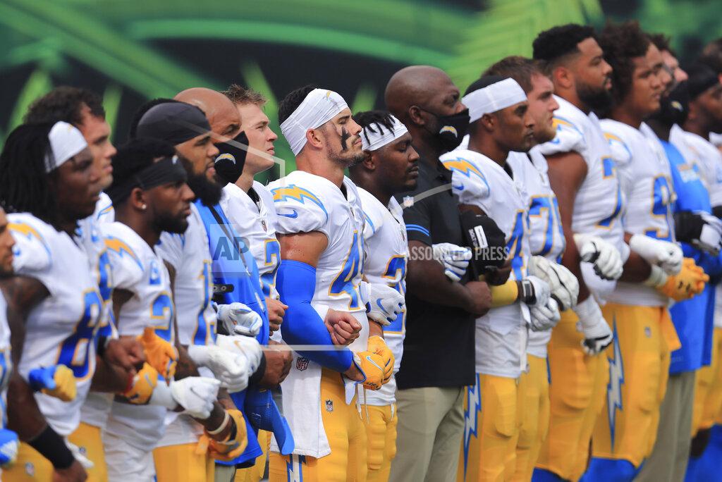 Aaron Doster The Los Angeles Chargers stand arm-in-arm as "Lift Every Voice and Sing" is played before an NFL football game against the Cincinnati Bengals, Sunday, Sept. 13, 2020, in Cincinnati. (AP Photo/Aaron Doster)