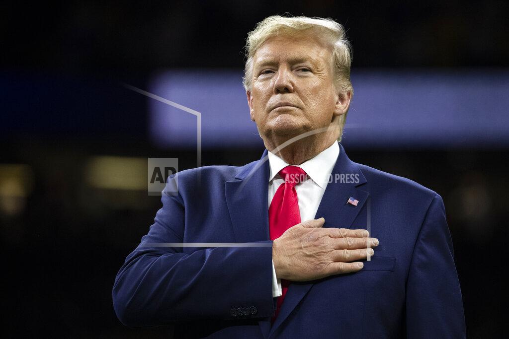Evan Vucci President Donald Trump stands for the national anthem before the beginning of the College Football Playoff National Championship game between LSU and Clemson, Monday, Jan. 13, 2020, in New Orleans. (AP Photo/ Evan Vucci)