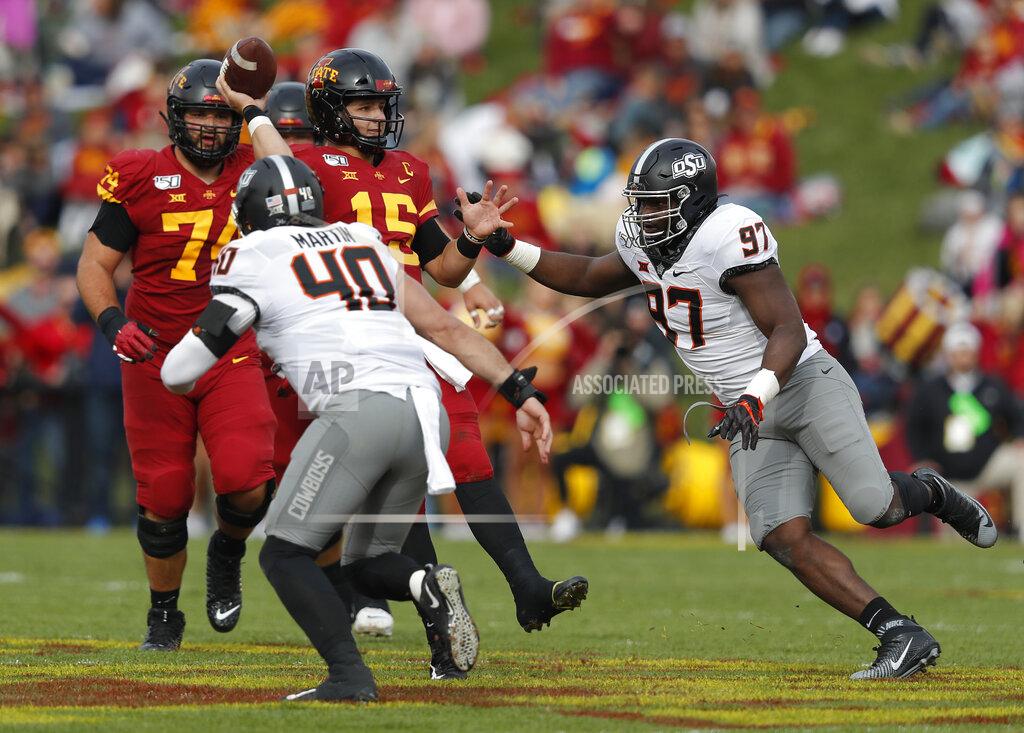 Matthew Putney Iowa State quarterback Brock Purdy, center, tries to get off a pass as he is pressured by Oklahoma State defensive end Brock Martin(40), and Oklahoma State defensive tackle Amadou Fofana (97), during the first half of an NCAA college football game, Saturday, Oct. 26, 2019, in Ames, Iowa. (AP Photo/Matthew Putney)