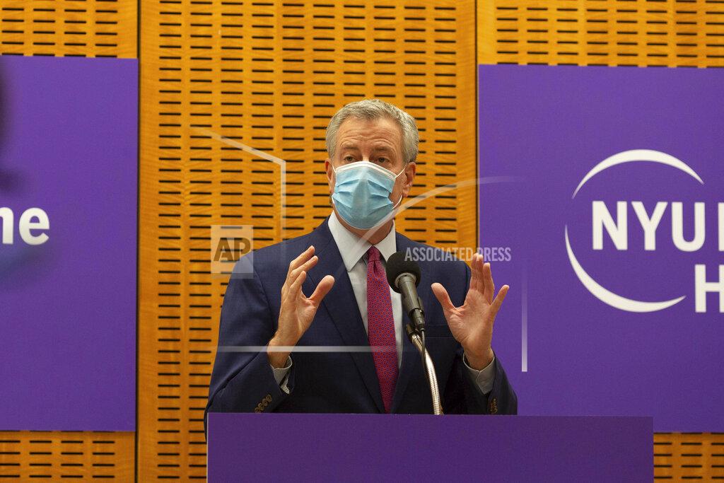 Mayor Bill de Blasio delivers remarks ahead of the first COVID-19 vaccinations at NYU-Langone Hospital on Monday, Dec. 14, 2020, in New York. Hundreds of thousands of health care workers across the country are expected to receive the vaccine this week. (AP Photo/Kevin Hagen).