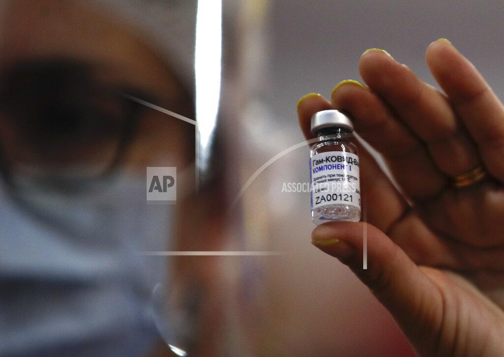 Natacha Pisarenko A nurse shows to the press a vial of Russia's Sputnik V vaccine for COVID-19 during a vaccination campaign inside River Plate stadium in Buenos Aires, Argentina, Tuesday, Feb. 2, 2021. (AP Photo/Natacha Pisarenko)