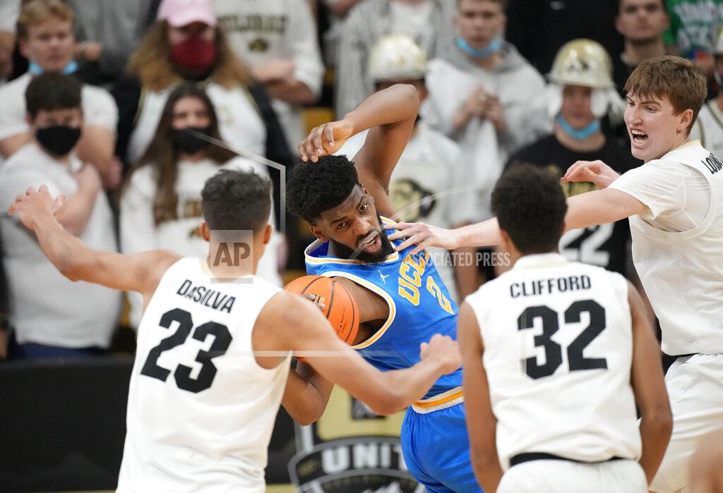 David Zalubowski UCLA forward Cody Riley, second from left, pulls in a loose ball as, from left, Colorado forward Tristan da Silva, guard Nique Clifford and center Lawson Lovering defend during the second half of an NCAA college basketball game Saturday, Jan. 22, 2022, in Boulder, Colo. UCLA won 71-65. (AP Photo/David Zalubowski)
