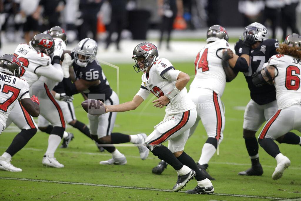 Isaac Brekken Tampa Bay Buccaneers quarterback Tom Brady (12) hands the ball off to Tampa Bay Buccaneers running back Ronald Jones (27) during the first half of an NFL football game against the Las Vegas Raiders, Sunday, Oct. 25, 2020, in Las Vegas. (AP Photo/Isaac Brekken)