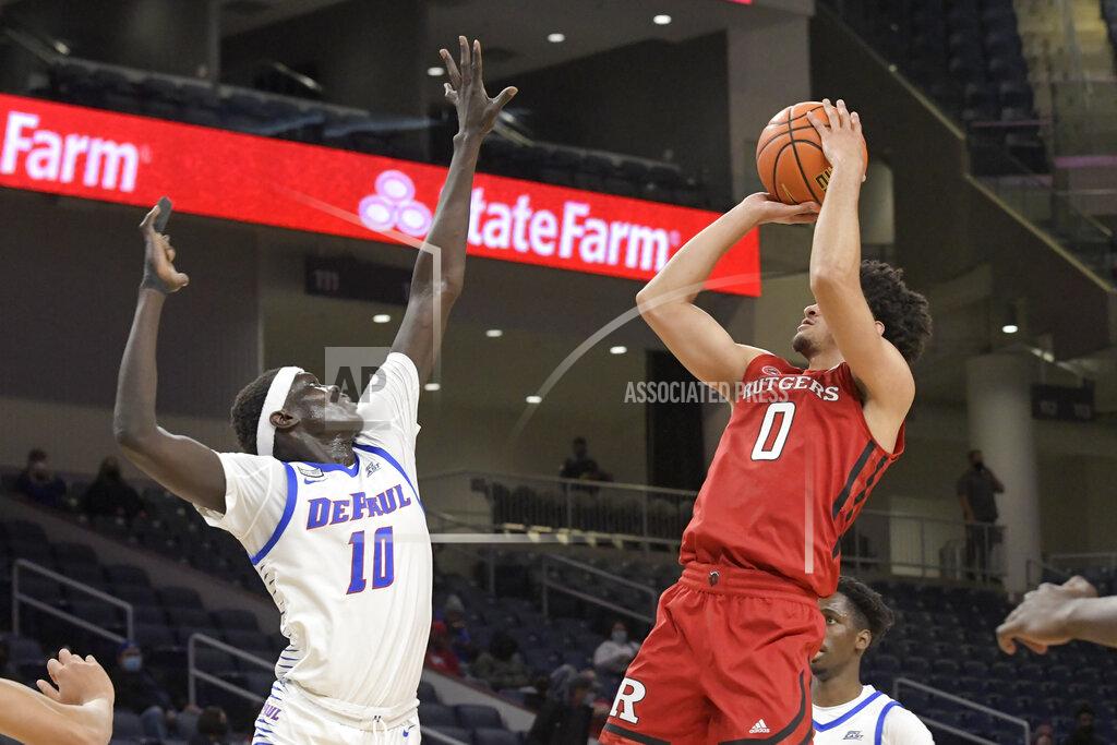 Mark Black Rutgers' Geo Baker (0) shoots over DePaul's Yor Anei (10) during the first half of an NCAA college basketball game Thursday, Nov. 18, 2021, in Chicago. (AP Photo/Mark Black)