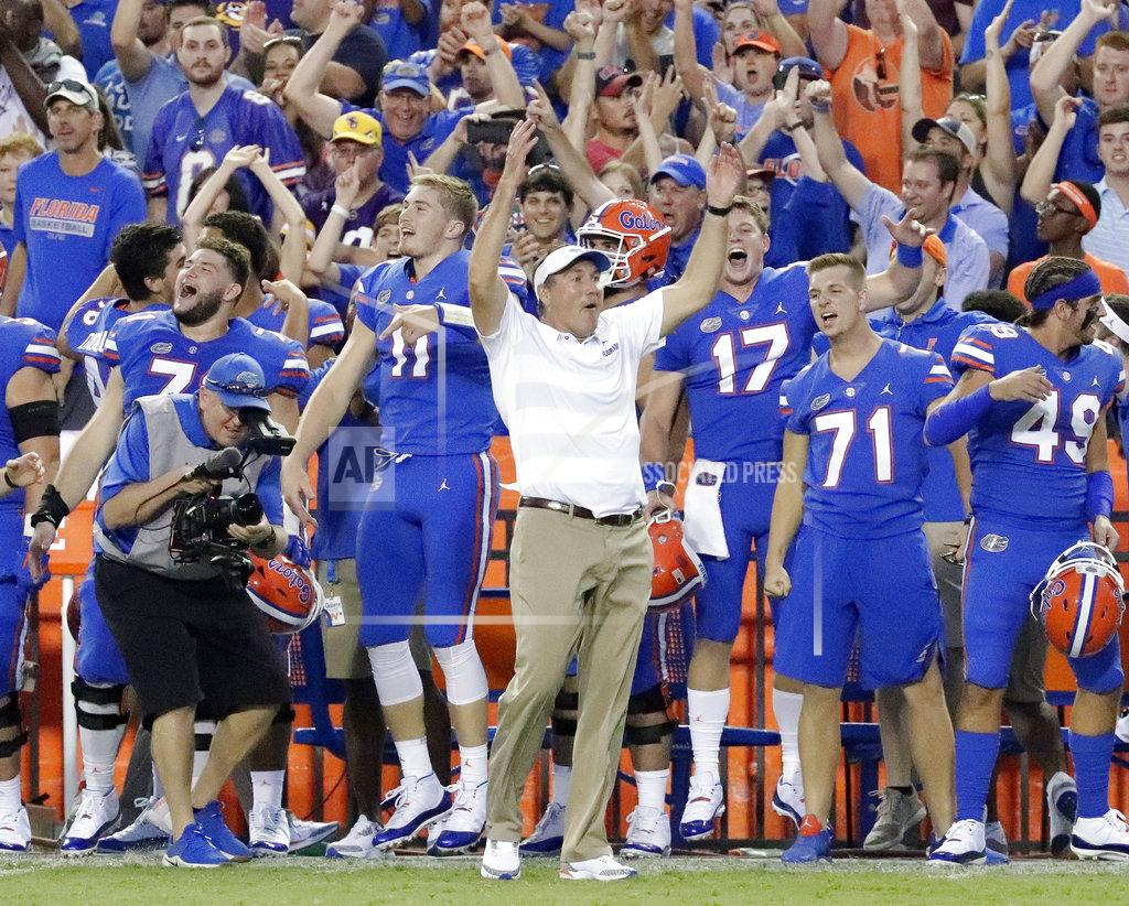John Raoux Florida head coach Dan Mullen, center, celebrates with players on the sidelines during the final moments of an NCAA college football game against LSU, Saturday, Oct. 6, 2018, in Gainesville, Fla. (AP Photo/John Raoux)