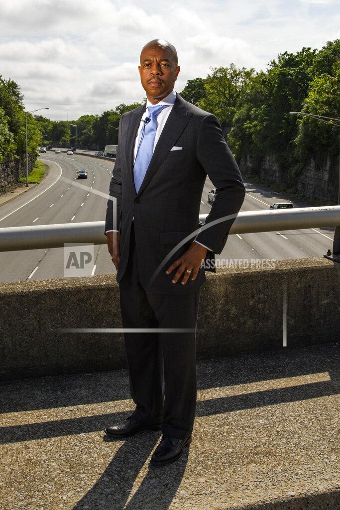 John Amis Tennessee State Rep. Harold Love, Jr. stands on an overpass over I-40, Monday, July, 19, 2021, on the north side of Nashville, Tenn. Love Jr.'s father, a Nashville city councilman, was forced to sell his family home near this spot to make way for the highway, but put up a fight in the 1960s against the rerouting of Interstate 40 because he believed it would stifle and isolate Nashville's Black community. Love Jr. is now part of a group pushing to build a cap across the highway that creates a community space to help reunify the city. (AP Photo/John Amis)