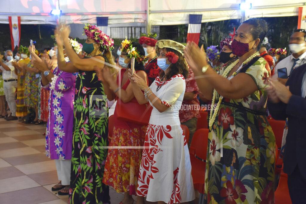 Esther Cuneo French Polynesians dressed in traditional clothes applause France's President Emmanuel Macron during his speech in Tahiti, French Polynesia in the Pacific Ocean, Tuesday, 27, 2021.President Emmanuel Macron reasserted France's presence in the Pacific on a visit to French Polynesia aimed in part at countering growing Chinese dominance in the region. (AP Photo/Esther Cuneo)