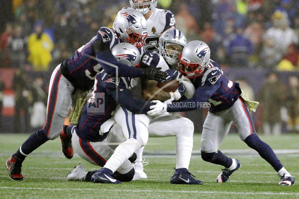 Elise Amendola New England Patriots defenders Jamie Collins, left, Kyle Van Noy and Jonathan Jones, right, tackle Dallas Cowboys running back Ezekiel Elliott in the first half of an NFL football game, Sunday, Nov. 24, 2019, in Foxborough, Mass. (AP Photo/Elise Amendola)
