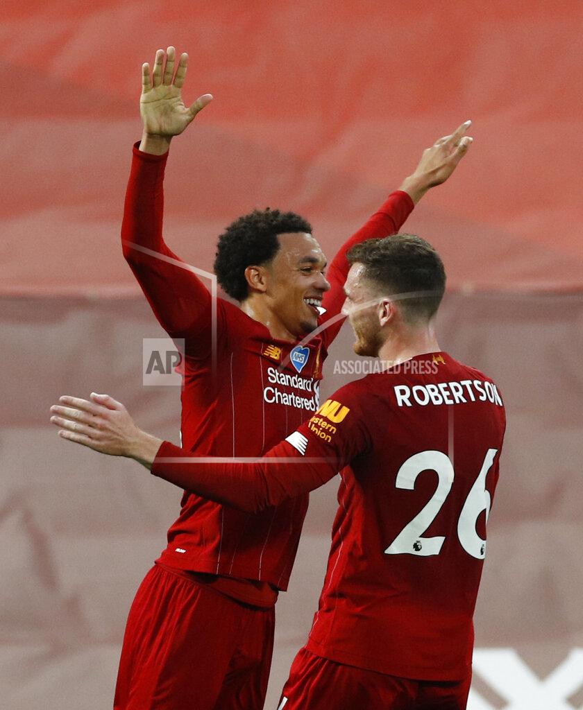 Phil Noble Liverpool's Trent Alexander-Arnold celebrates after scoring his sides 2nd goal of the game with teammate Liverpool's Andrew Robertson from a free kick during the English Premier League soccer match between Liverpool and Chelsea at Anfield Stadium in Liverpool, England, Wednesday, July 22, 2020. (Phil Noble/Pool via AP)
