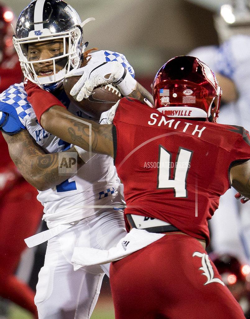 Bryan Woolston Louisville safety TreSean Smith (4) tackles Kentucky wide receiver Lynn Bowden Jr. (1) during the first half of an NCAA college football game in Louisville, Ky., Saturday, Nov. 24, 2018. (AP Photo/Bryan Woolston)