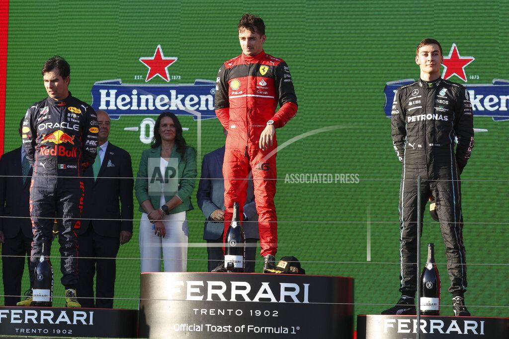 Asanka Brendon Ratnayake Ferrari driver Charles Leclerc, centre, of Monaco stands on the podium after winning the Australian Formula One Grand Prix in Melbourne, Australia, Sunday, April 10, 2022. Red Bull driver Sergio Perez, left, of Mexico was second and Mercedes driver George Russell of Britain finished third. (AP Photo/Asanka Brendon Ratnayake)