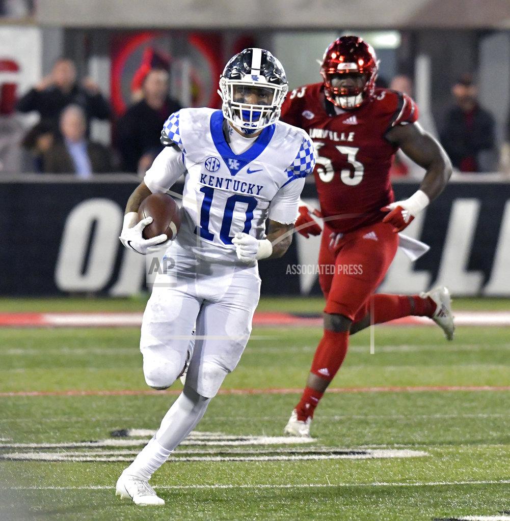 Timothy D. Easley Kentucky running back Asim Rose (10) runs from Louisville defensive end Amonte Caban (53) during the second half of an NCAA college football game in Louisville, Ky., Saturday, Nov. 24, 2018. Kentucky won 56-10. (AP Photo/Timothy D. Easley)