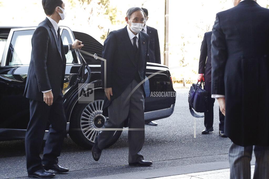 Rodrigo Reyes Marin Prime Minister Yoshihide Suga wearing a face mask arrives at the National Theatre of Japan to attend the national memorial service for the victims of the March 11, 2011, earthquake and tsunami in Tokyo, Thursday, March 11, 2021. Japan is marking the 10th anniversary of the earthquake, tsunami and nuclear disaster with many survivors’ lives are still on hold. (Rodrigo Reyes Marin/Pool Photo via AP)