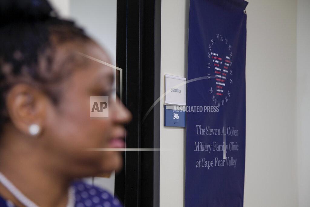 Sarah Blake Morgan This April 22, 2020, photo shows a sign that says "The Steven A. Cohen Military Family Clinic at Cape Fear Valley" in Fayetteville, N.C. Anthony Hassan, the president and chief executive officer of Cohen, said he doesn't believe the country’s mental health system is prepared for the surge likely to happen from the pandemic. Cohen is opening 10 new centers by the end of next year and hiring more staff. (AP Photo/Sarah Blake Morgan)