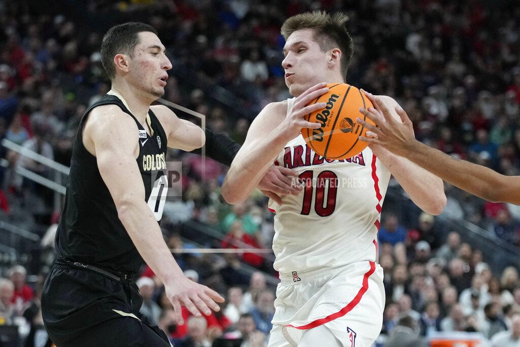 John Locher Arizona's Azuolas Tubelis (10) drives into Colorado's Luke O'Brien (0) during the first half of an NCAA college basketball game in the semifinal round of the Pac-12 tournament Friday, March 11, 2022, in Las Vegas. (AP Photo/John Locher)