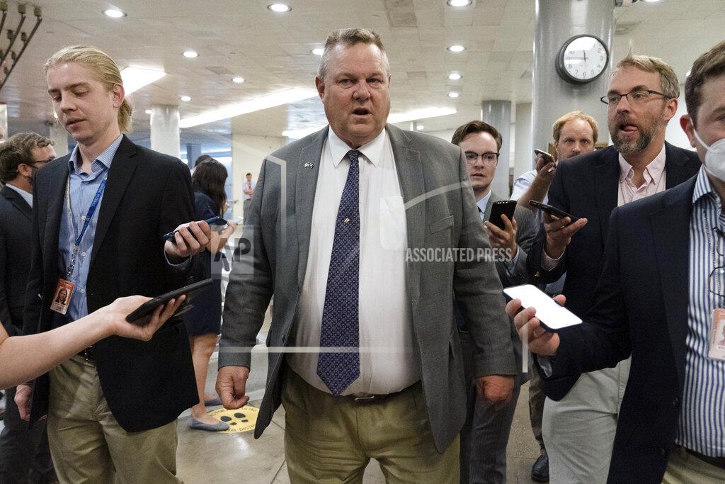 Jose Luis Magana Sen. Jon Tester, D-Mont., talks to reporters as he walks to the Senate chamber ahead of a test vote scheduled by Democratic Leader Chuck Schumer of New York on the bipartisan infrastructure deal senators brokered with President Joe Biden, on Capitol Hill, in Washington, Wednesday, July 21, 2021. Republicans prepared to block the vote by mounting a filibuster over what they see as a rushed and misguided process. (AP Photo/Jose Luis Magana)
