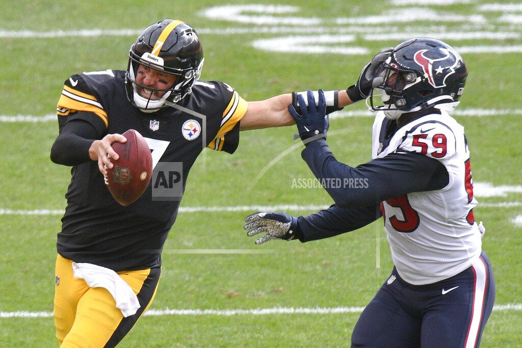 Don Wright Pittsburgh Steelers quarterback Ben Roethlisberger (7) stiff-arms Houston Texans outside linebacker Whitney Mercilus (59) while trying to scramble for a first down in the second half of an NFL football game, Sunday, Sept. 27, 2020, in Pittsburgh. The Steelers did not get the first down. (AP Photo/Don Wright)