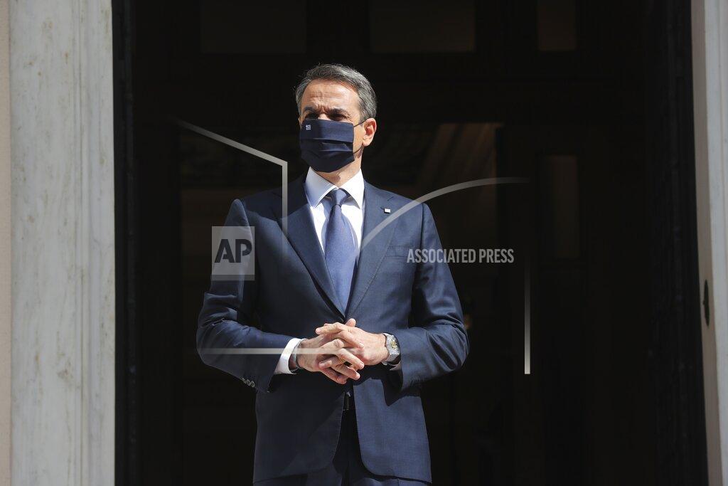 Petros Giannakouris Greece's Prime Minister Kyriakos Mitsotakis waits for the arrival of the Russian Prime Minister Mikhail Mishustin at Maximos Mansion in Athens, Wednesday, March 24, 2021. Greece is kicking off two days of celebrations to mark the bicentenary of the start of the country's war of independence, although events are far more muted than originally planned due to the coronavirus pandemic. (AP Photo/Petros Giannakouris)