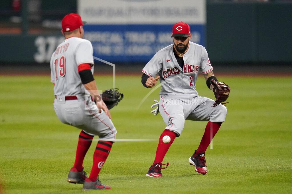 Jeff Roberson A ball hit by St. Louis Cardinals' Harrison Bader drops in for a double between Cincinnati Reds right fielder Nick Castellanos, right, and first baseman Joey Votto (19) during the third inning of a baseball game Saturday, Aug. 22, 2020, in St. Louis. (AP Photo/Jeff Roberson)