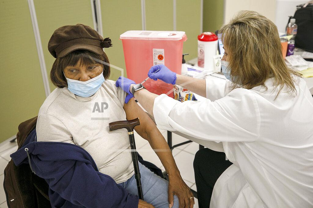 Mary Dudley, of Meriden, is administered the first dose of a COVID-19 vaccine from Meriden Health Dept. Associate Health Director Stephanie Denya at the Max E. Muravnick senior center on West Main Street in Meriden, Conn., Thursday, Feb. 4, 2021. (Dave Zajac/Record-Journal via AP)