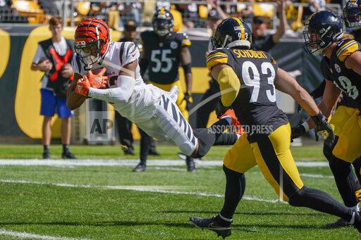 Cincinnati Bengals wide receiver Tyler Boyd (83) dives past Pittsburgh Steelers inside linebacker Joe Schobert (93) for a touchdown during the first half an NFL football game, Sunday, Sept. 26, 2021, in Pittsburgh. (AP Photo/Gene J. Puskar)